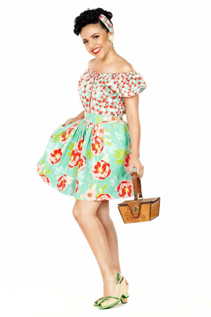 Model wearing a 1940s-inspired April Moon Aqua floral skirt with the Mary Blouse from Lil' Lou Lou's Buen Viaje Collection.