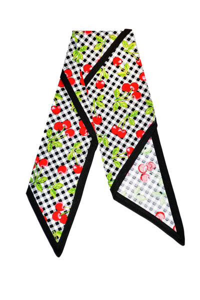 Flat lay of the Cherry Picnic Rosie Bandana featuring cherry print, black gingham fabric, and signature black trim.