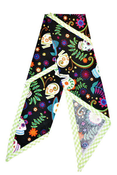 Flat lay of the Colorful Skull Rosie Bandana featuring colorful skull print and green gingham trim.
