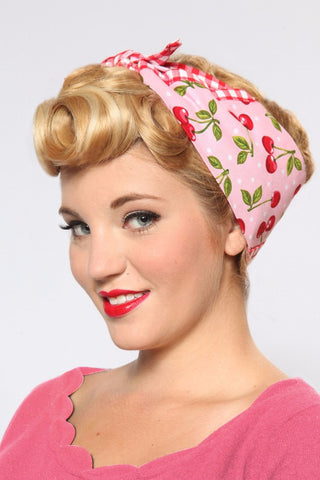 Blonde model wearing the Pink Cherry Dots Rosie Bandana with vintage pin curls and retro pinup styling.