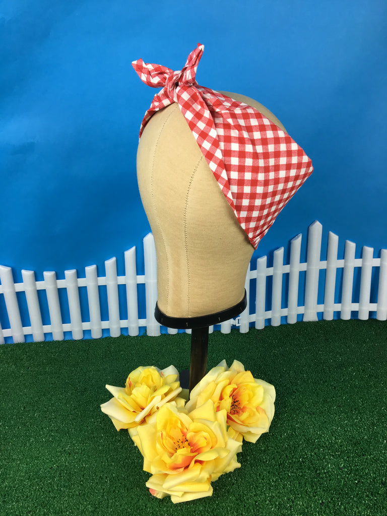 Red gingham Rosie Bandana displayed on a mannequin head with yellow April Moon roses.