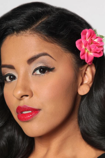 Model wearing a hot pink Rosita hair flower in vintage-inspired hairstyle.