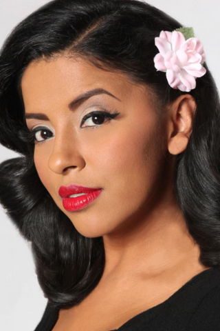 Model wearing the pink Rosita hair flower in a vintage hairstyle.